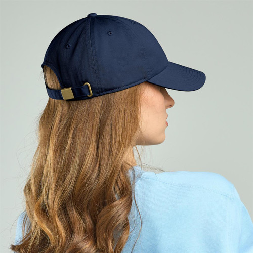 A navy blue Dad Hat with an adjustable strap, seen from the back on a person with long hair.