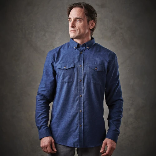 A blue button-up shirt with two chest pockets and a collar, featuring a logo on the front.
