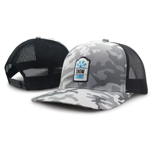 A trucker cap in grey snow camouflage with a black mesh back and a badge on the front.