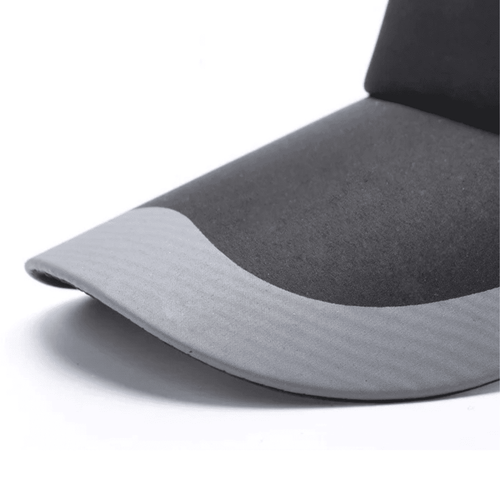 A sun visor in black and grey with a curved brim and a smooth texture, featuring a logo.