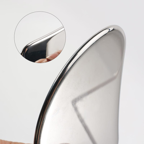A stainless steel Gua Sha massage tool with a shiny, smooth surface and a curved edge, featuring a close-up detail.