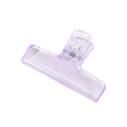 A translucent purple plastic clip with a spring mechanism for securing items.