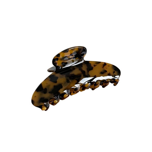 A tortoiseshell acetate hair clip with a curved design and multiple gripping prongs.