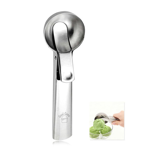 A stainless steel ice cream scoop with a lever mechanism, displayed beside a bowl of green ice cream.