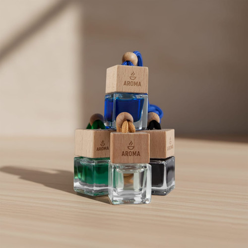 A stack of four small glass bottles with wooden tops, featuring blue, green, black, and clear liquids, and a logo.