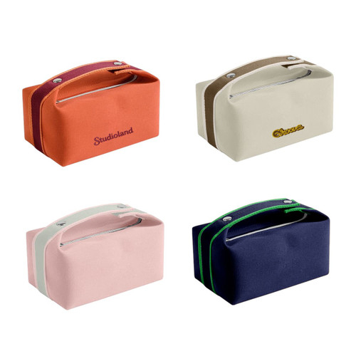A portable canvas cosmetic bag in orange, cream, pink, and navy, featuring zippers and handles. Some have branding.
