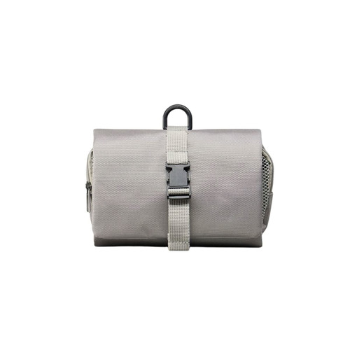 A grey folding travel toiletry bag with a strap closure and a hanging loop, featuring a textured fabric surface.