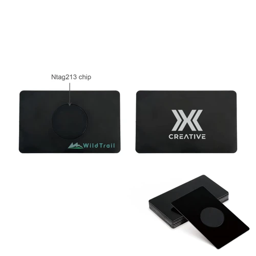 A black metal business card featuring a central NFC chip and branding on both sides.