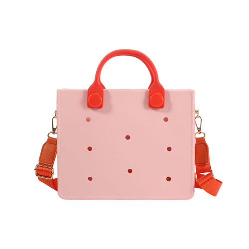 A casual tote bag in pink with red handles and dots, featuring a detachable strap and a logo.