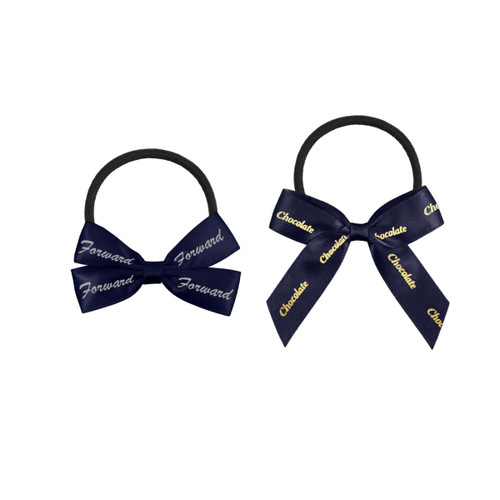 Two elastic hair bows in navy blue with ribbon detailing, featuring inscriptions in gold. One bow is larger than the other.
