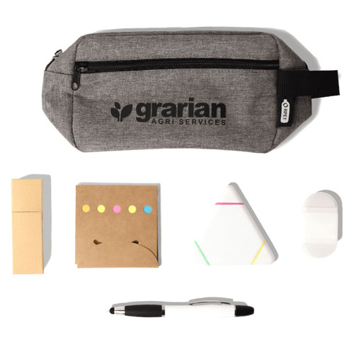 A grey pencil case with a logo contains sticky notes, a triangular notepad, a white eraser, and a black pen.