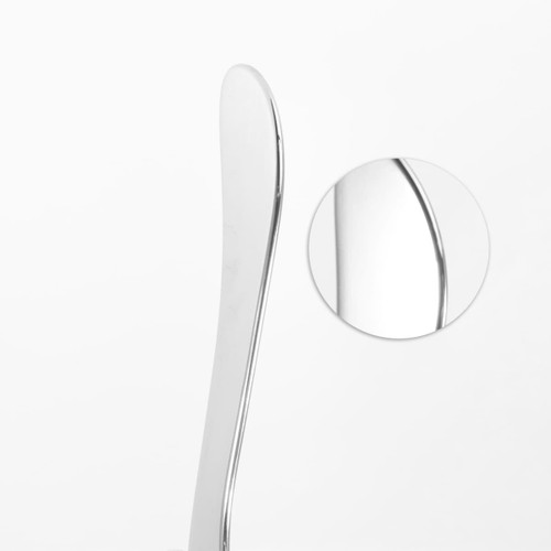 A silver facial Gua Sha massage tool with a sleek, curved design, featuring a close-up of its polished surface.