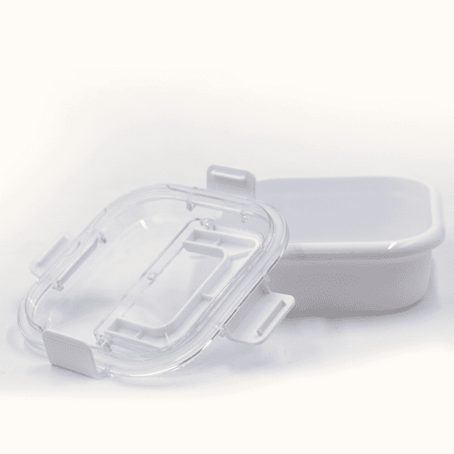A white lunch box with a transparent lid, featuring clips for secure closure.