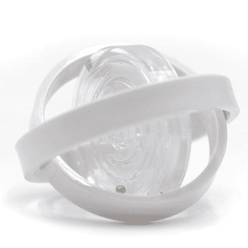 A clear fidget toy with a white band encircling a spinning inner component. Features a smooth, transparent design.