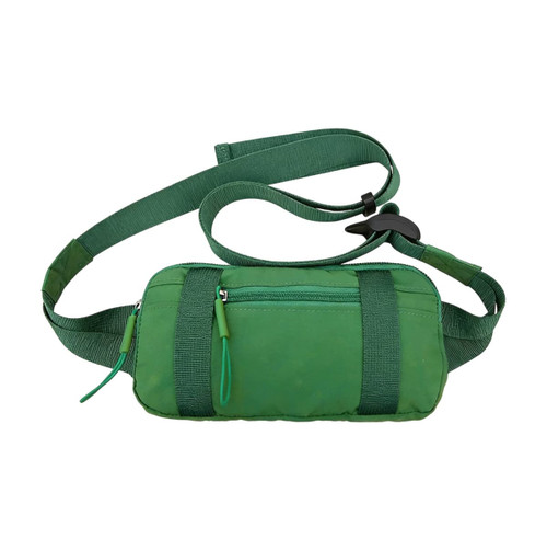A green travel fanny pack with adjustable straps and a zippered front pocket, featuring a logo.