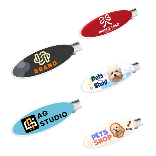 A set of oval acrylic hair clips in red, black, white, and multi-coloured designs, featuring various logos and images.