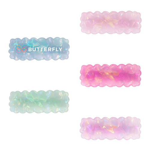 Wavy rectangle hair clips in iridescent blue, pink, and green hues with a glossy finish and a logo.