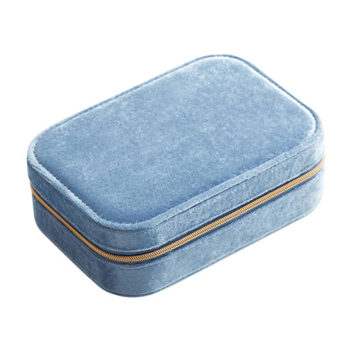 A blue velvet jewellery box with a compartment and a gold zipper, featuring a soft exterior.