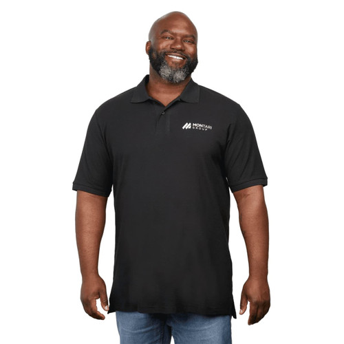 A man wearing a black eco-friendly polo shirt with a logo on the chest, smiling and standing.