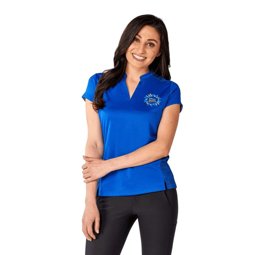 A woman is wearing a vibrant blue short sleeve performance polo shirt with a logo on the chest.