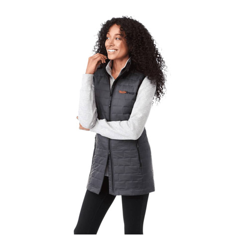A lightweight, insulated puffer vest in black, featuring a high collar and zip closure, modelled by a smiling woman.