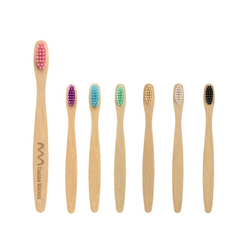 Eight small bamboo toothbrushes in various pastel colours, featuring a logo on one handle.