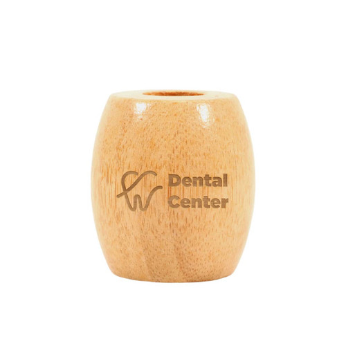 A bamboo toothbrush stand in a light wood colour with a logo on the front.