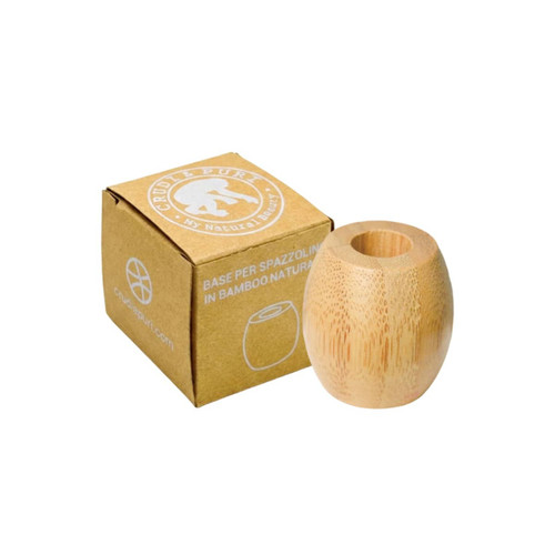 A bamboo toothbrush stand with a rounded design, placed beside a small cardboard box featuring a logo.