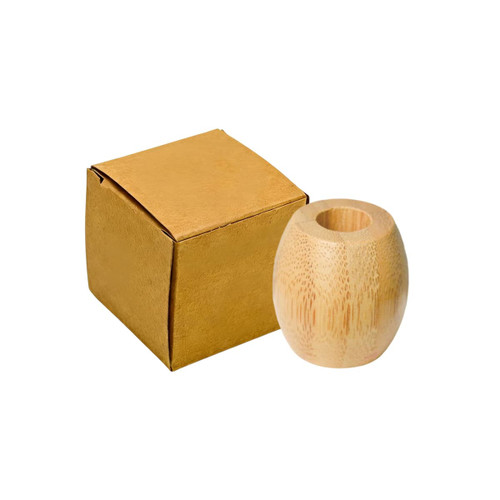 A bamboo toothbrush stand in a natural tone next to a golden box. The stand has a smooth, rounded shape.