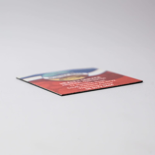 A 50mm x 50mm fridge magnet with a colourful design and a logo on it, featuring a flat edge.