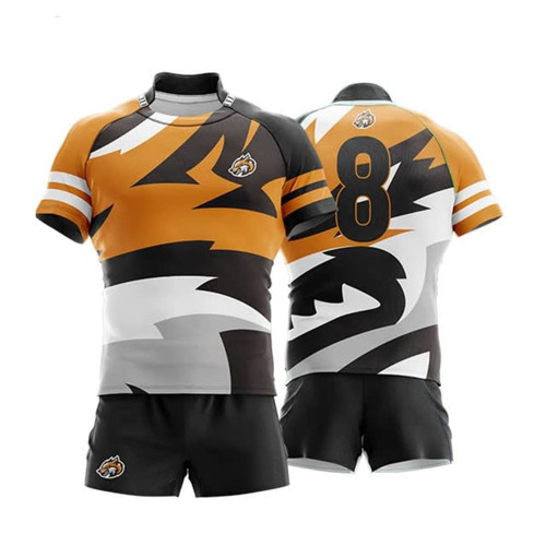 A rugby jersey in orange, black, and grey, featuring a bold design and a logo. Shorts are included in the ensemble.
