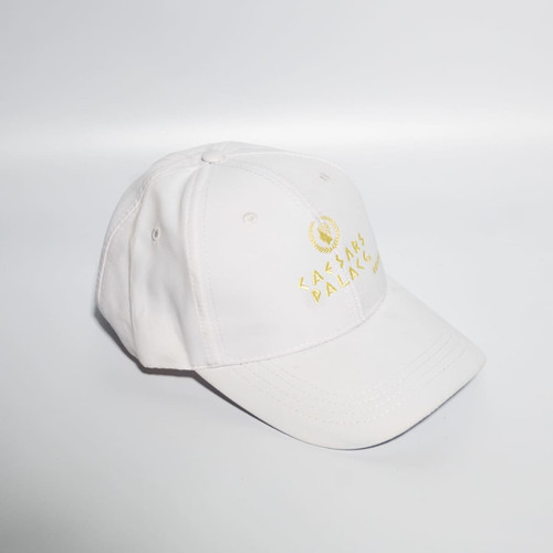 A white baseball cap with a Velcro strap and a logo on the front.