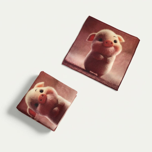 Two pink face washers featuring a cute cartoon pig design on a brown background. One is folded, the other flat.