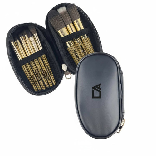 A case with nine brushes featuring gold handles and black bristles, enclosed in a black zippered pouch.