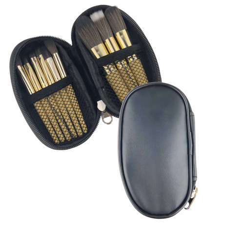 A black case opening to reveal nine brushes with golden handles and mesh pockets. The case has a zip closure.