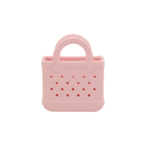 A pink mini EVA bag charm with perforated design and a handle, featuring a small opening at the top.