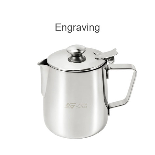 A stainless steel milk frothing pitcher with a lid, featuring a handle and a branded logo.