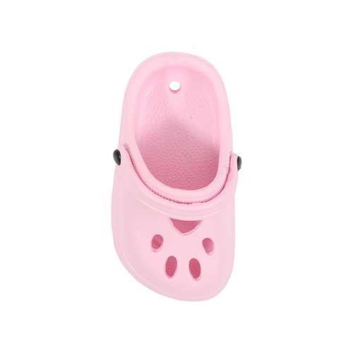 A pink paw-shaped clog shoe fridge magnet featuring ventilated holes and a black button detail.