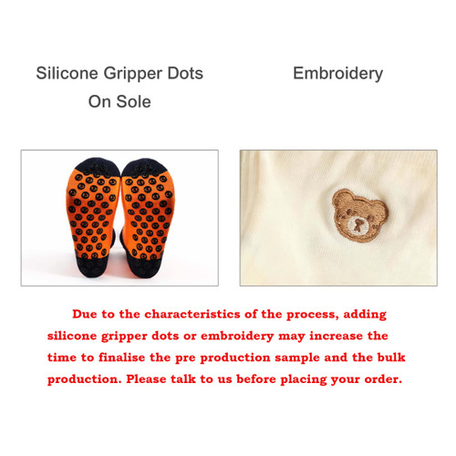 A pair of sport socks featuring silicone gripper dots on the sole and an embroidered bear design.