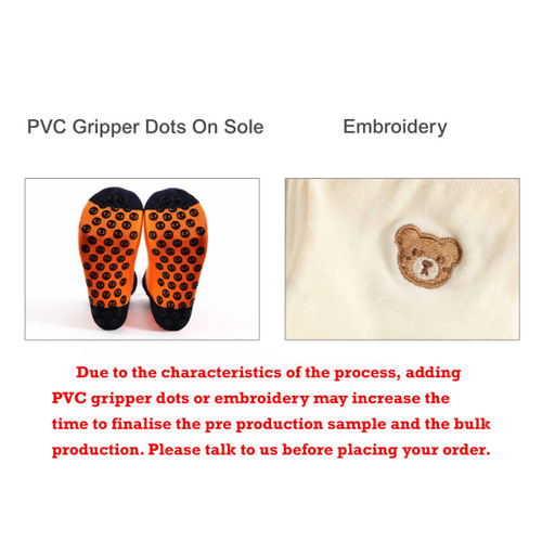 A pair of low cut socks featuring orange PVC gripper dots on the sole and an embroidered design.