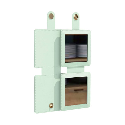 A square folding pocket mirror in mint green with two reflective surfaces and a fastening tab.