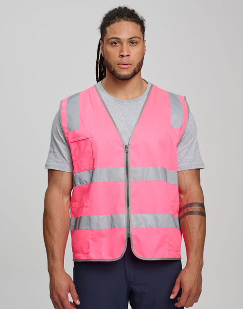 A pink hi-vis safety zip vest with reflective stripes and utility pockets, worn by a model.