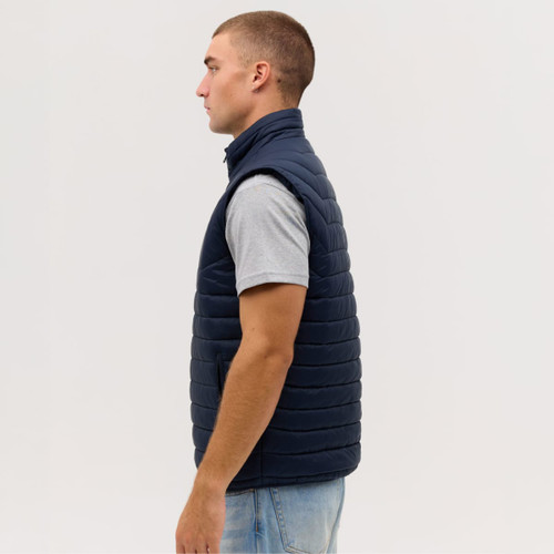 A navy blue puffer vest displayed on a model from the side, featuring a high collar and a sleek design.