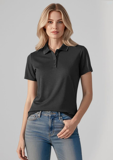 A dark grey women's short sleeve polo shirt with a collar and logo, paired with jeans.
