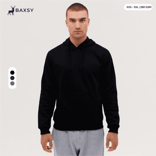 A black hoodie with a front pocket and drawstring hood, modelled by a person standing against a plain background.