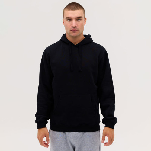 A man wearing a black hoodie with a front pocket, paired with grey sweatpants. The hoodie has a drawstring hood.