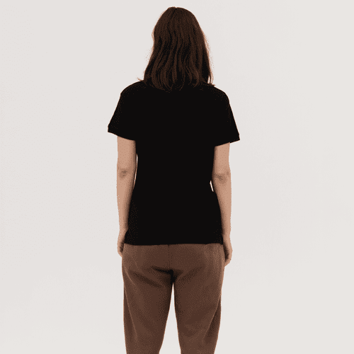 A black women's polo shirt is displayed from the back, featuring a simple design and a relaxed fit.