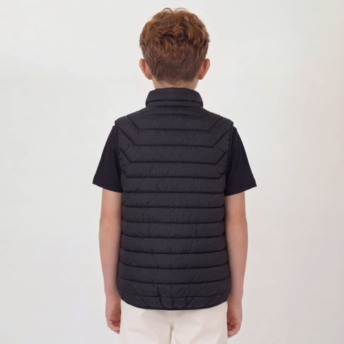 A black puffer vest with a high collar, viewed from the back, worn by a child with curly hair.
