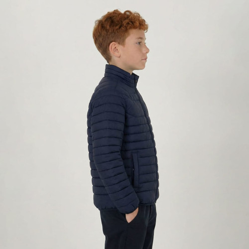 A youth puffer jacket in navy blue, featuring a zip-up front and a fitted design, shown on a profile view.