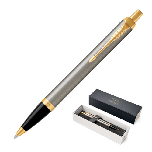 A brushed stainless steel ballpoint pen with gold accents, presented in a black box with branding.